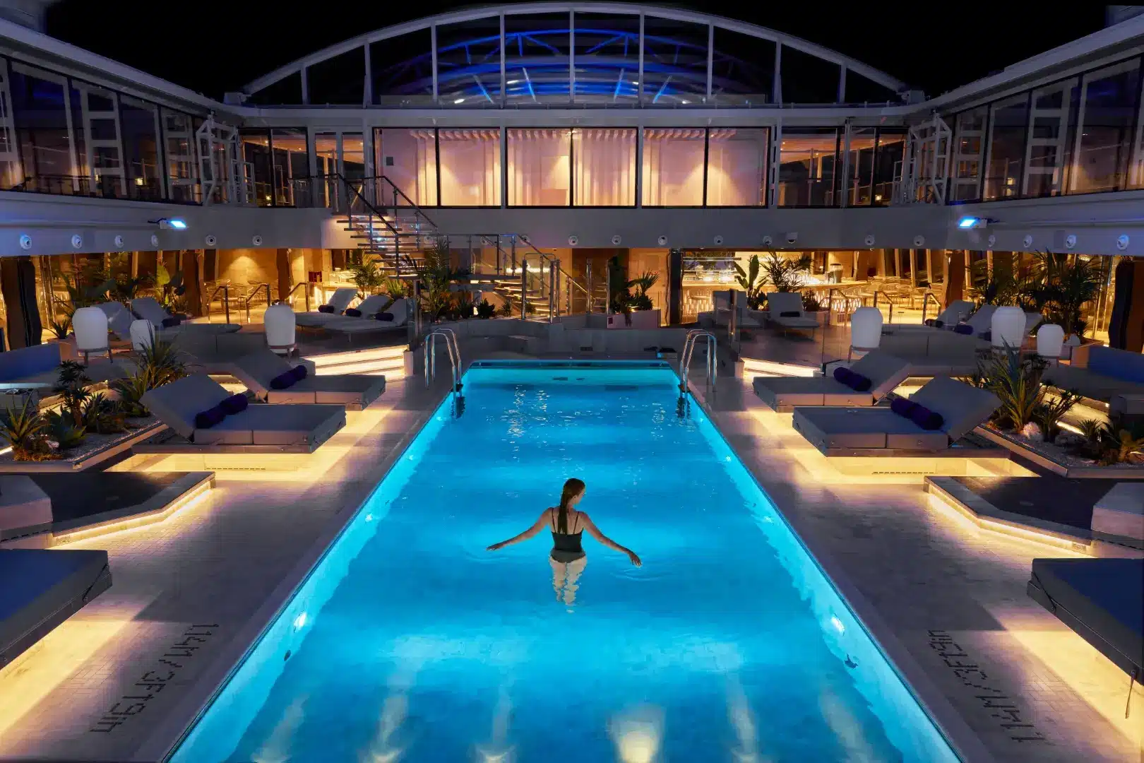Illuminated Conservatory pool aboard EXPLORA I at night